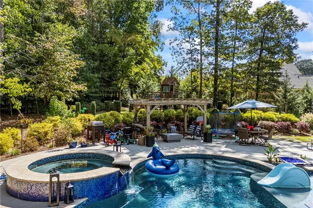 an aerial view of a house with a yard and seating area