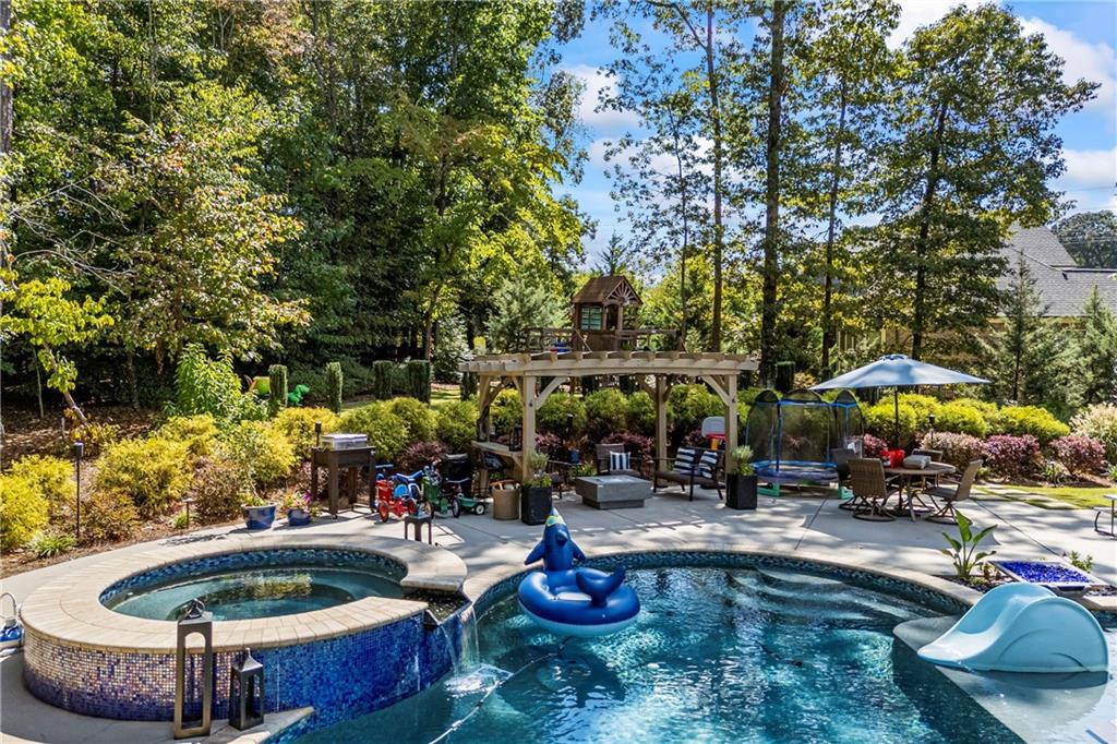 3111 Old Thompson Mill Road Buford, GA 30519 - Photo 48 of 52 a swimming pool with outdoor seating and plants
