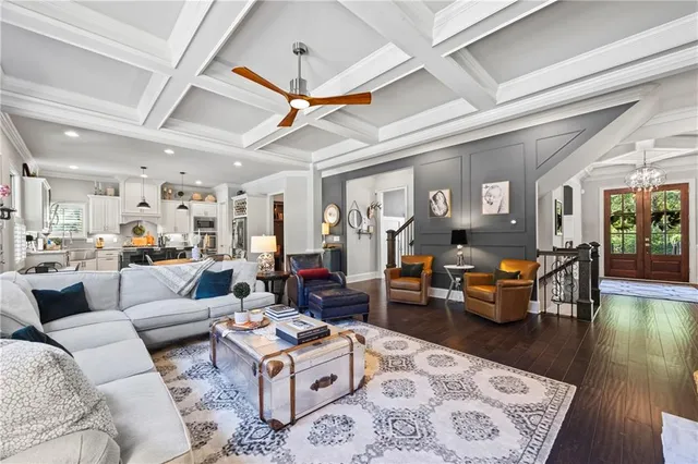 a living room with furniture kitchen view and a table