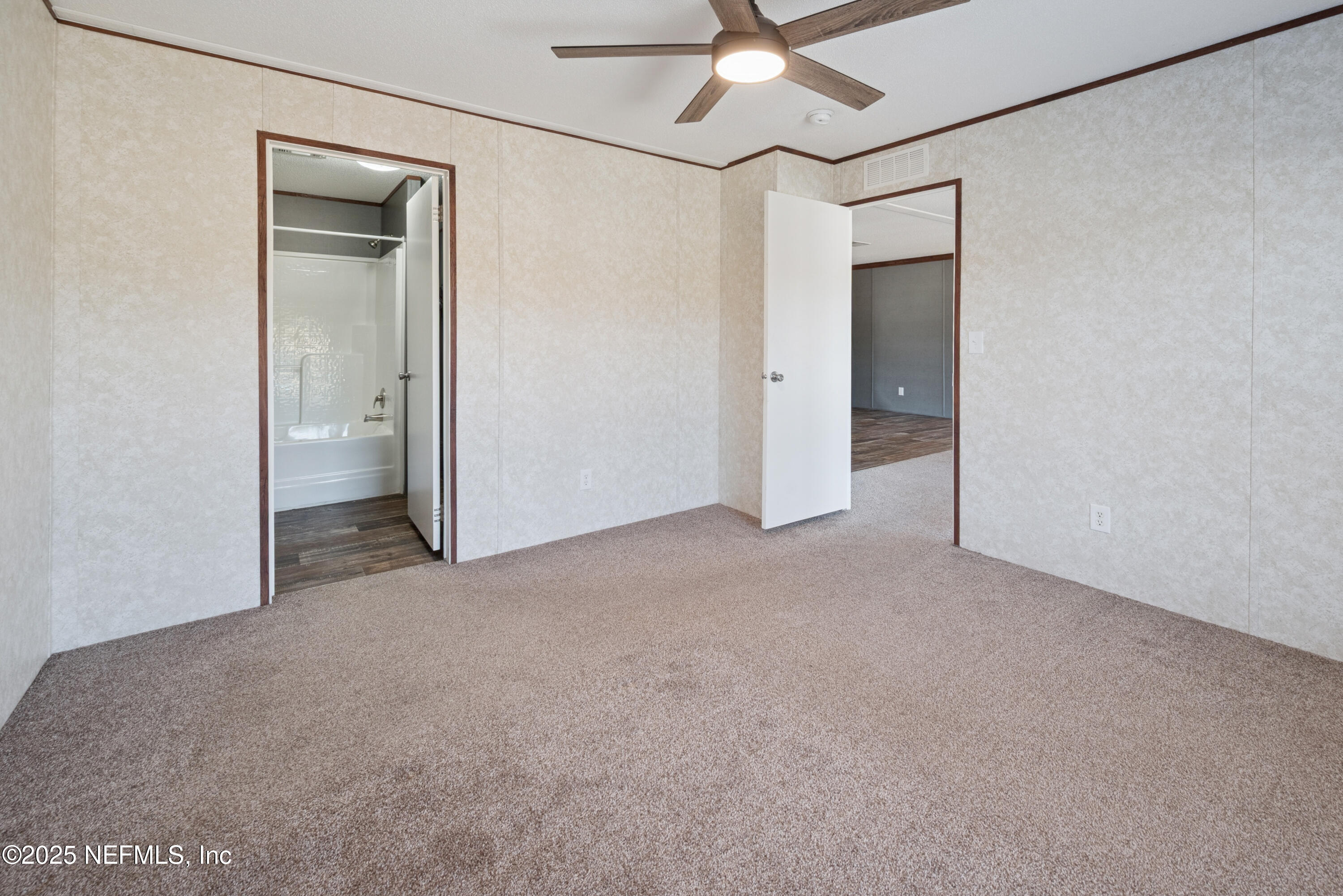 10379 Southwest 45th Place Lake Butler, FL 32054 - Photo 12 of 24 a view of an empty room and a chandelier fan