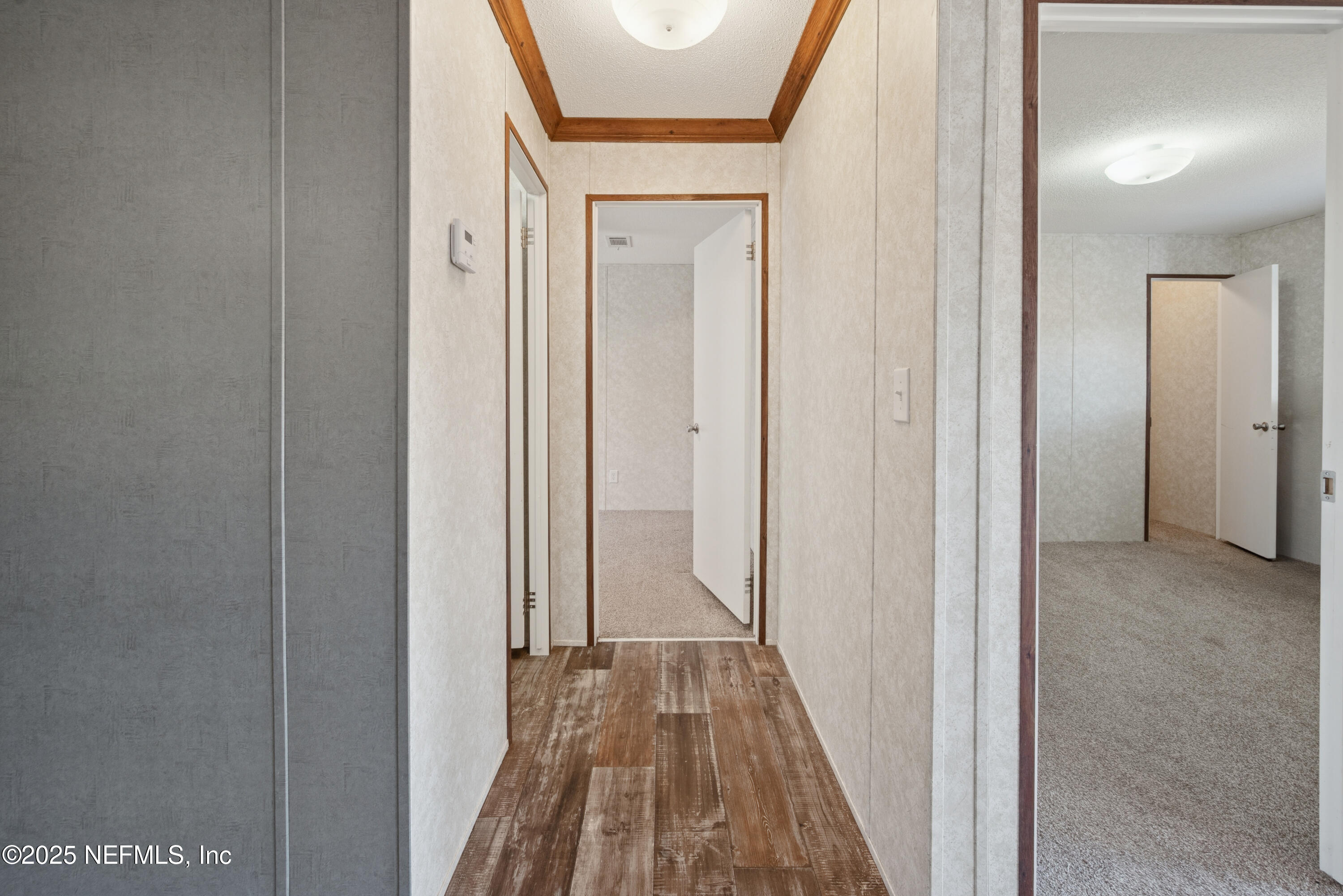 10379 Southwest 45th Place Lake Butler, FL 32054 - Photo 15 of 24 a view of a hallway with wooden floor and a bathroom