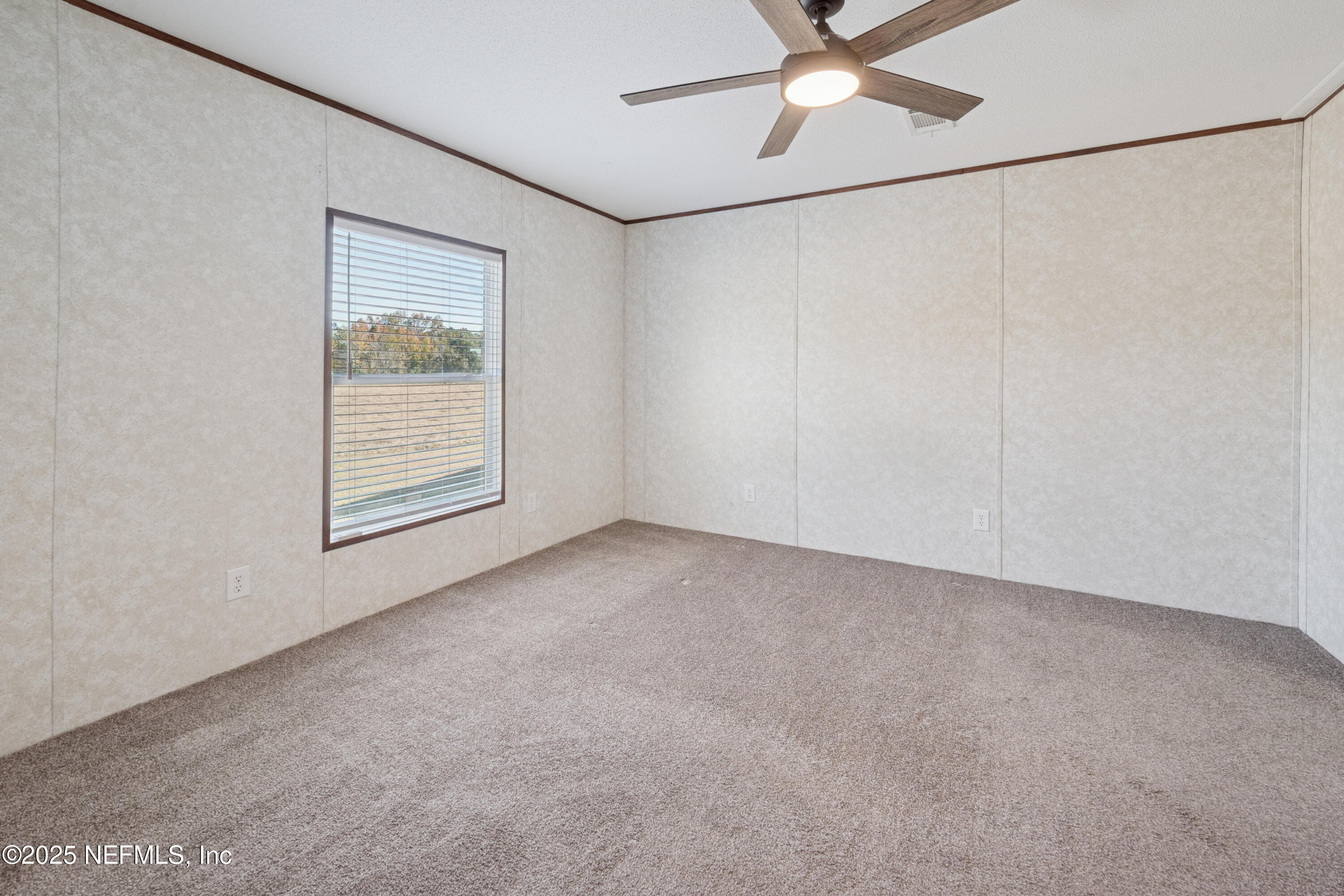 10379 Southwest 45th Place Lake Butler, FL 32054 - Photo 17 of 24 an empty room with windows and fan