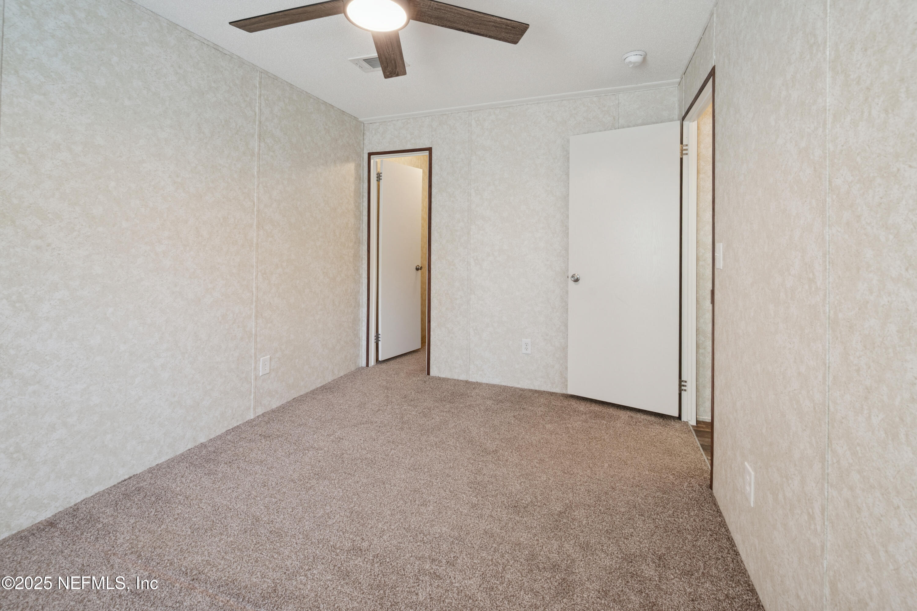 10379 Southwest 45th Place Lake Butler, FL 32054 - Photo 18 of 24 an empty room with a ceiling fan and a window