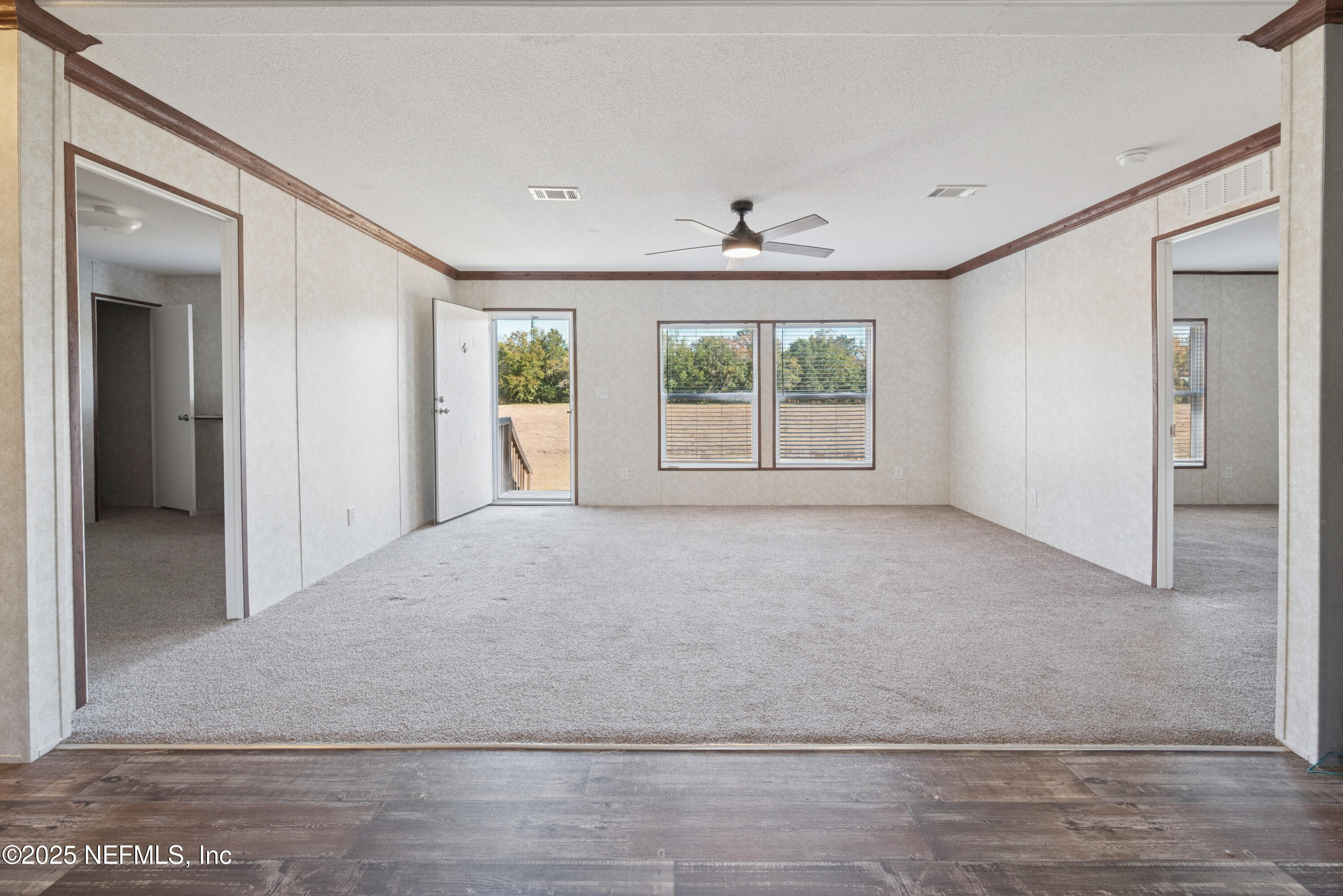 10379 Southwest 45th Place Lake Butler, FL 32054 - Photo 6 of 24 an empty room with windows and closet