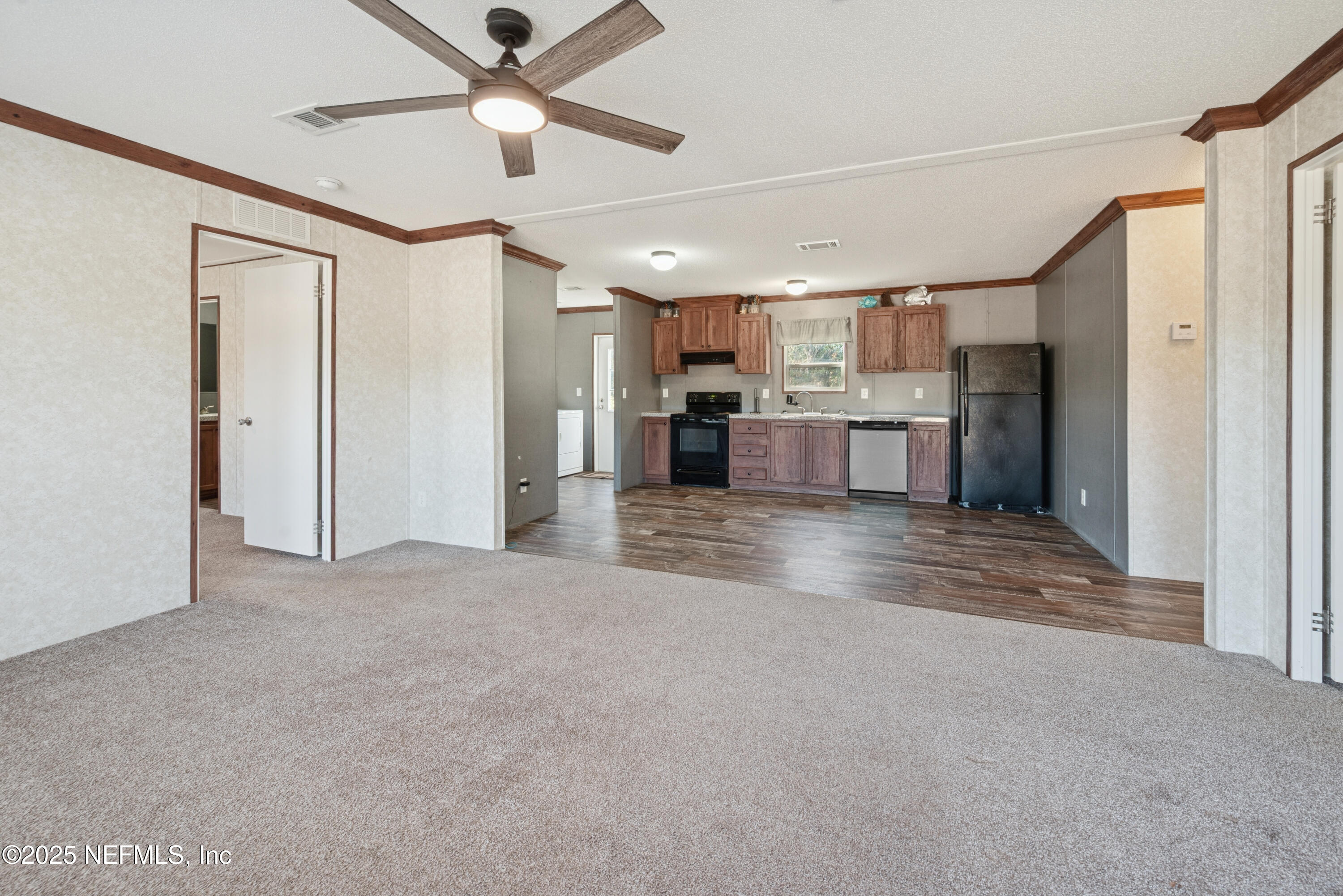 10379 Southwest 45th Place Lake Butler, FL 32054 - Photo 7 of 24 a view of a kitchen with a sink and a refrigerator