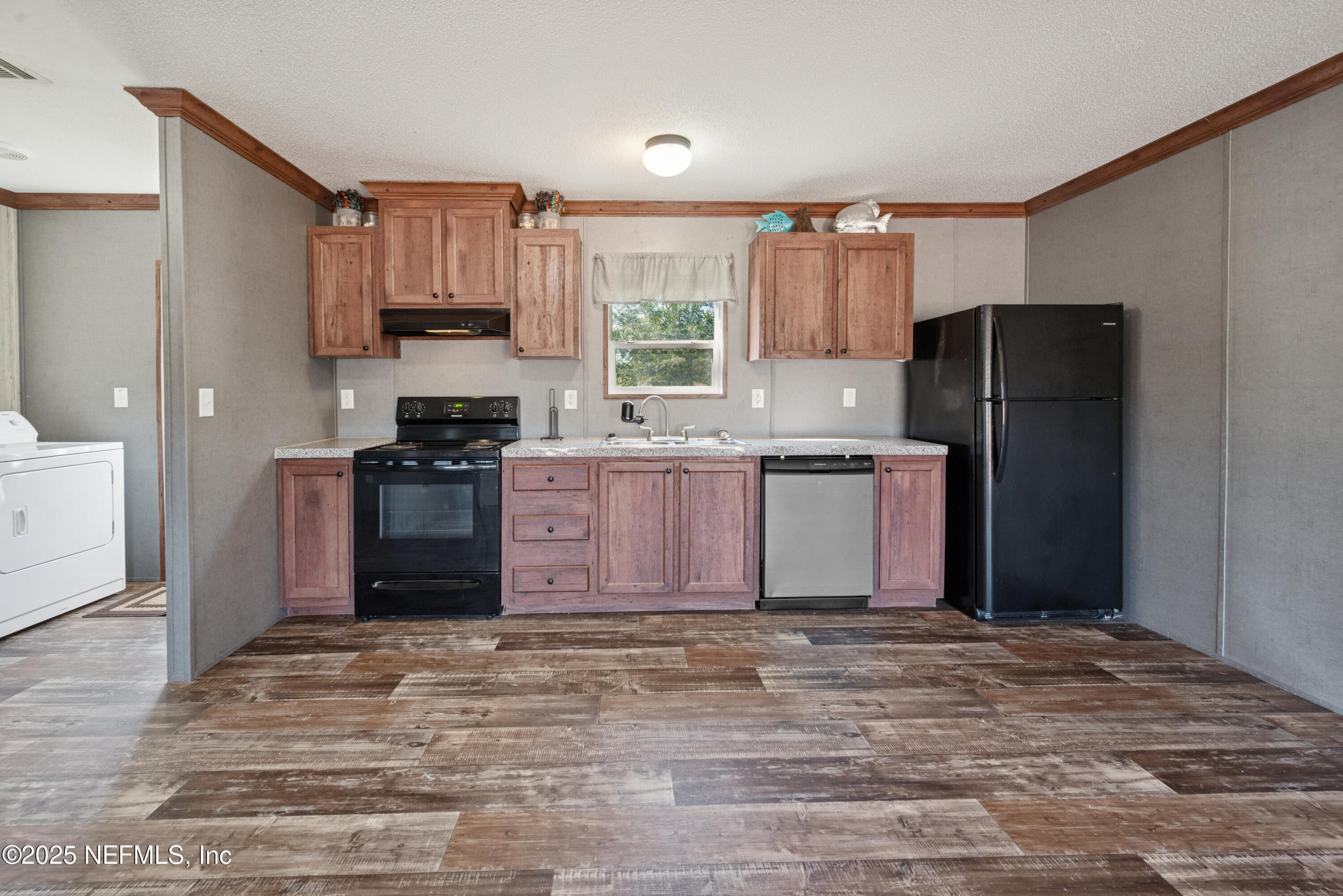 10379 Southwest 45th Place Lake Butler, FL 32054 - Photo 9 of 24 a kitchen with granite countertop a refrigerator stove top oven and sink