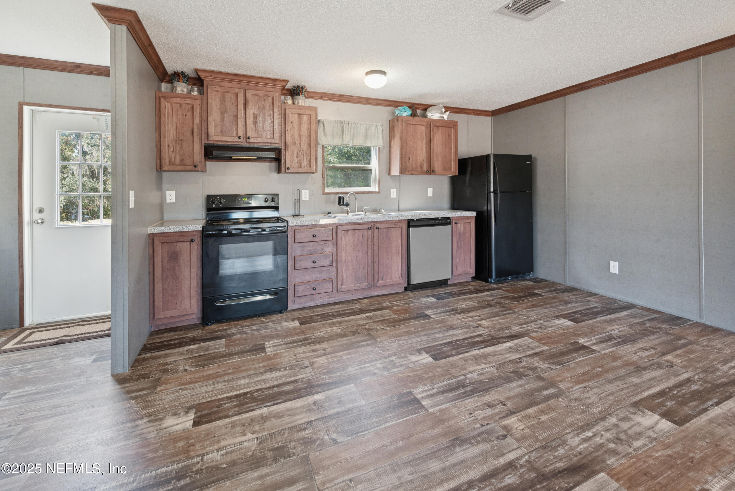 10379 Southwest 45th Place Lake Butler, FL 32054 - Photo 10 of 24 a kitchen with stainless steel appliances granite countertop a refrigerator stove top oven and sink