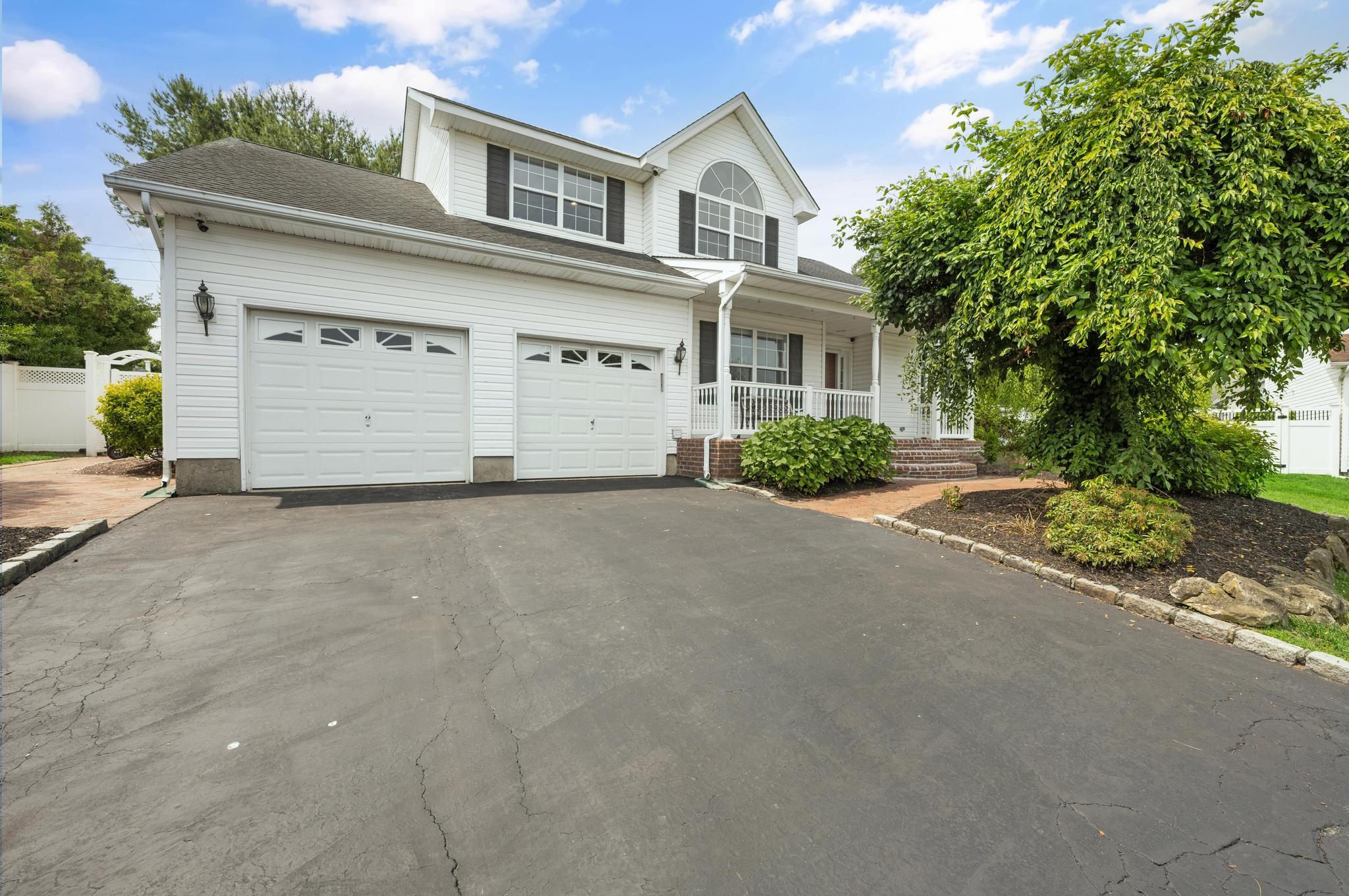 8 Tecumseh Court Commack, NY 11725 - Photo 1 of 1 a front view of a house with a yard and garage