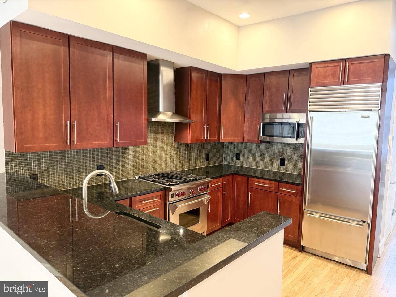 26 North 3rd Street, Unit 3 Philadelphia, PA 19106 - Photo 14 of 50 a kitchen with stainless steel appliances granite countertop a sink refrigerator and microwave