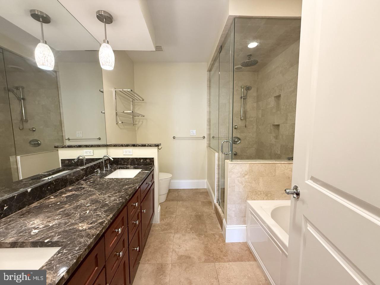 26 North 3rd Street, Unit 3 Philadelphia, PA 19106 - Photo 25 of 50 a bathroom with a granite countertop tub sink and mirror