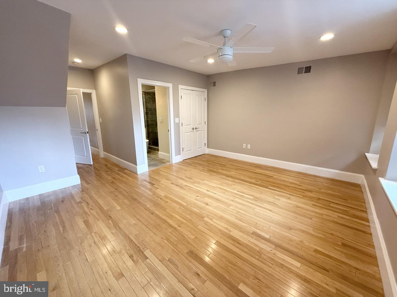 26 North 3rd Street, Unit 3 Philadelphia, PA 19106 - Photo 31 of 50 an empty room with wooden floor and entrance to ceiling window