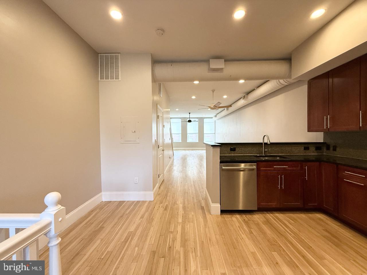 26 North 3rd Street, Unit 3 Philadelphia, PA 19106 - Photo 6 of 50 a kitchen with a sink wooden floor and stainless steel appliances