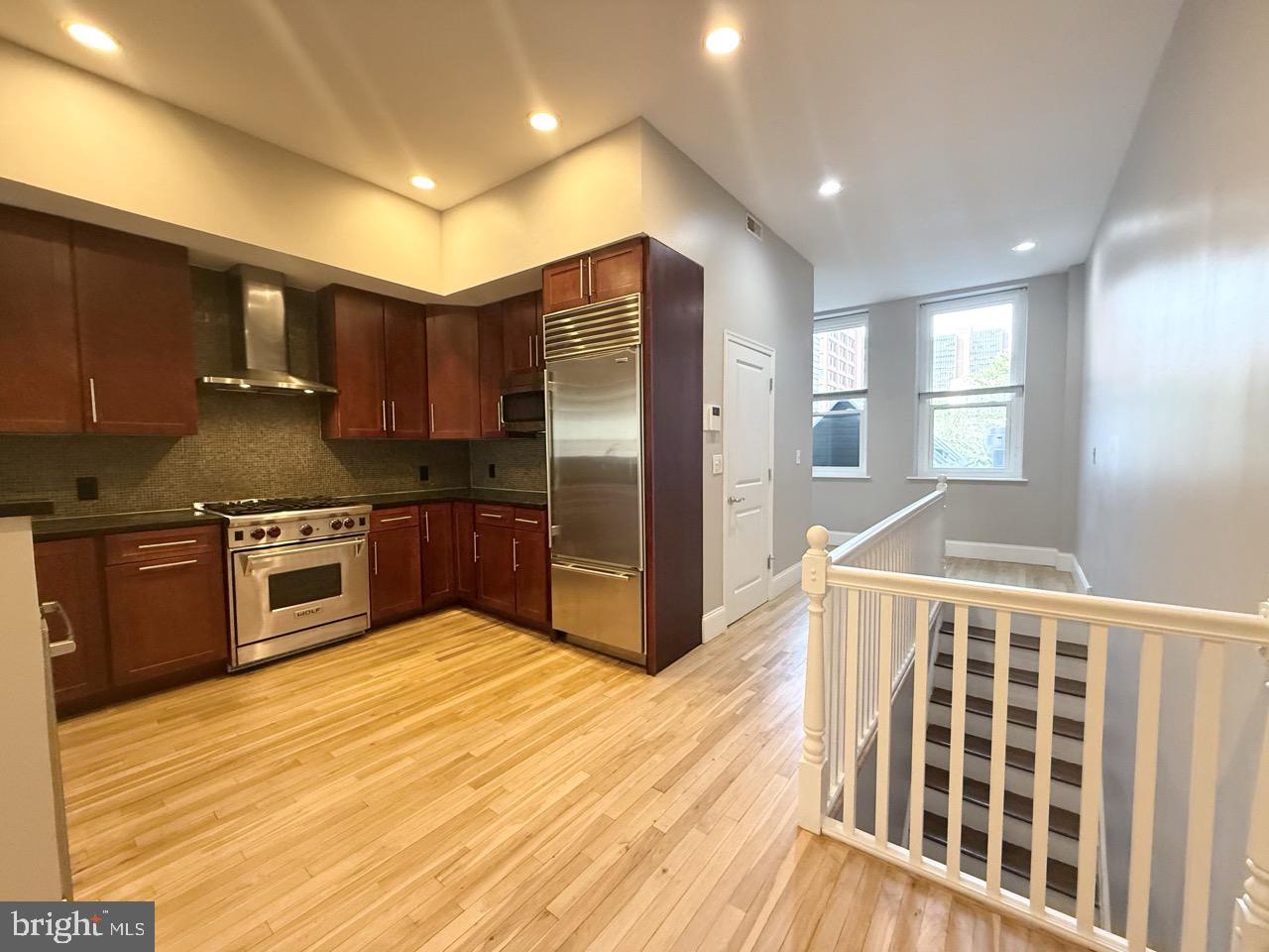 26 North 3rd Street, Unit 3 Philadelphia, PA 19106 - Photo 9 of 50 a kitchen with stainless steel appliances kitchen island granite countertop a refrigerator and a stove top oven