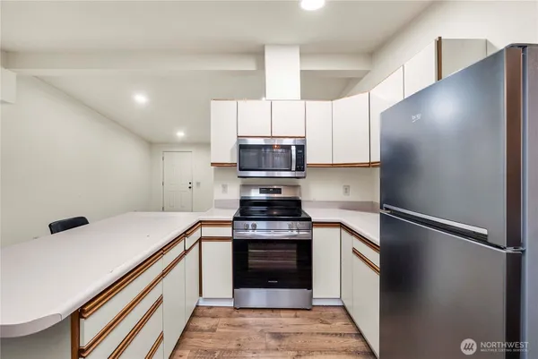 a kitchen with a stove and a refrigerator