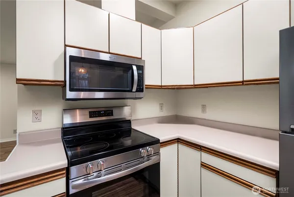 a kitchen with stainless steel appliances a stove and a microwave