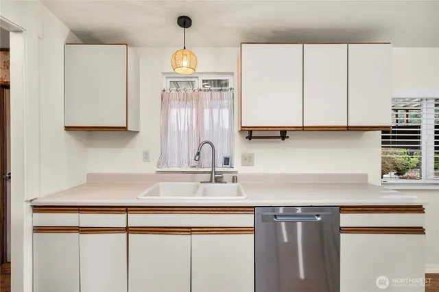 a kitchen with stainless steel appliances granite countertop a sink a stove and a microwave