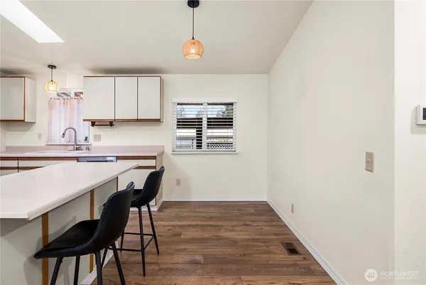 a kitchen with a table and chairs in it