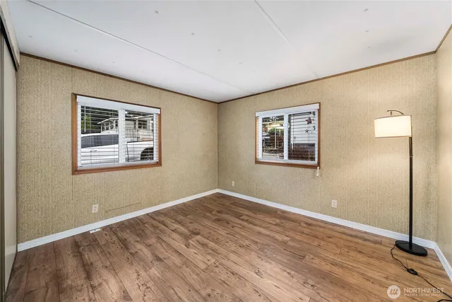 a view of a room with wooden floor and window