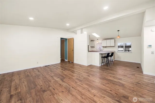 a view of kitchen with cabinets and wooden floor