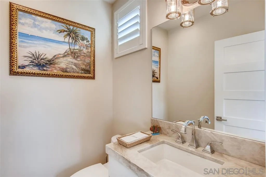 1765 Tattenham Road Encinitas, CA 92024 - Photo 17 of 25 a bathroom with a granite countertop sink mirror and vanity