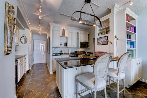 a kitchen with stainless steel appliances granite countertop a stove and a refrigerator