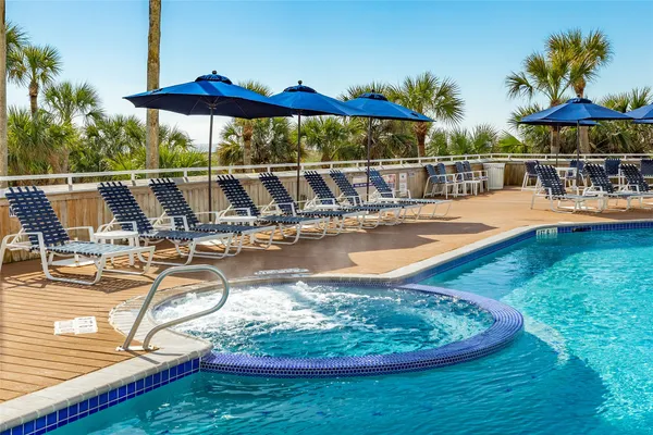 a view of a swimming pool with chairs