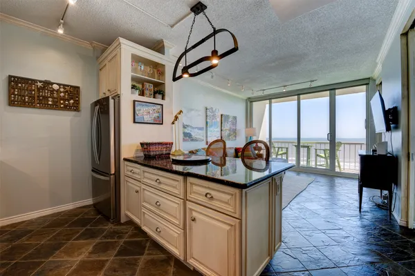 a kitchen with stainless steel appliances granite countertop a stove and a refrigerator