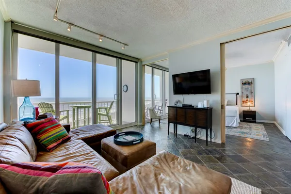 a bedroom with furniture and a flat screen tv
