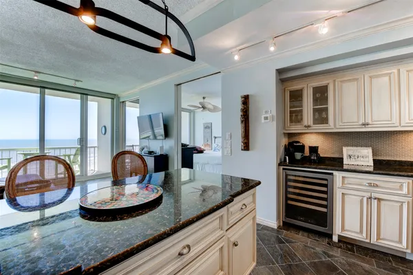a kitchen with granite countertop a sink and a stove