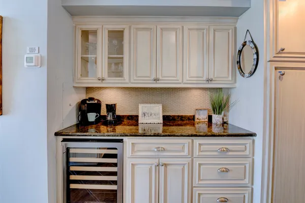 a kitchen with stainless steel appliances granite countertop white cabinets and a stove