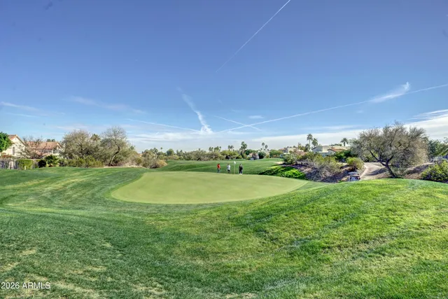 a view of a golf course with an trees