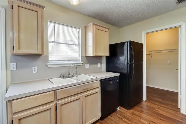 a kitchen with stainless steel appliances granite countertop a refrigerator and a sink