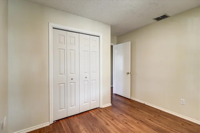 a view of an empty room and wooden floor