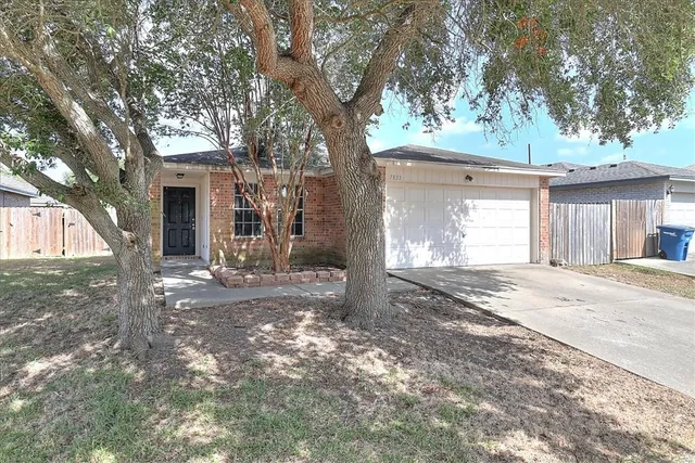 a view of a house with a yard and garage