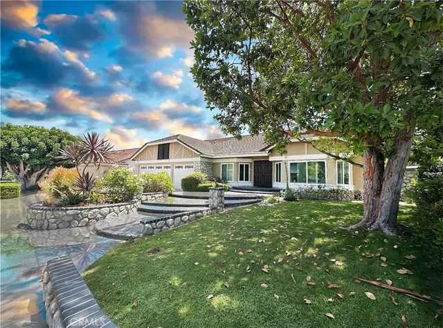 a front view of a house with garden