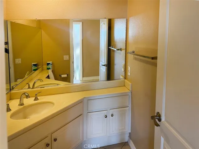 a bathroom with a tub sink and mirror