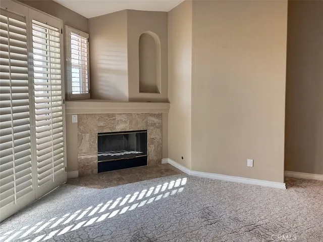 a large white room with a mirror and a shower
