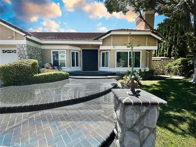 a view of a house with backyard sitting area and garden