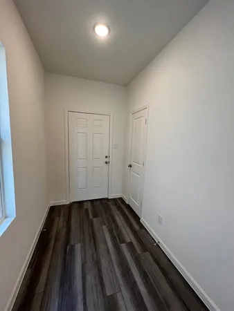 a view of room with wooden floor