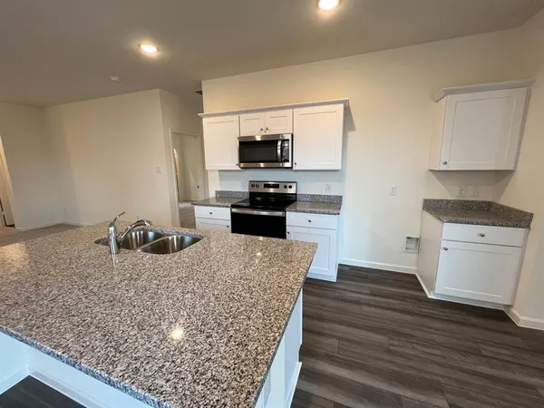 a kitchen with sink microwave and stove