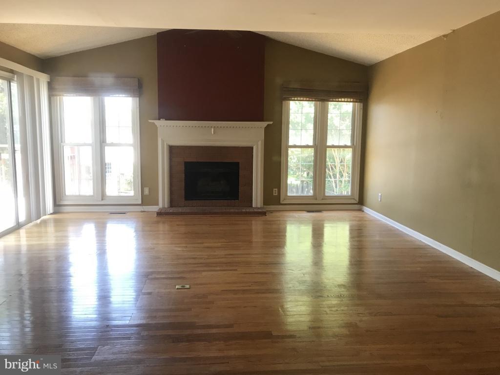 9 Leamington Road Fredericksburg, VA 22406 - Photo 2 of 12 a view of empty room with wooden floor and fireplace