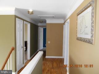 9 Leamington Road Fredericksburg, VA 22406 - Photo 12 of 12 a view of a hallway with wooden floor and staircase