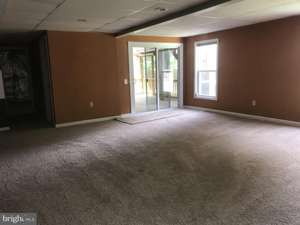 9 Leamington Road Fredericksburg, VA 22406 - Photo 6 of 12 a view of a big room with windows and chandelier fan