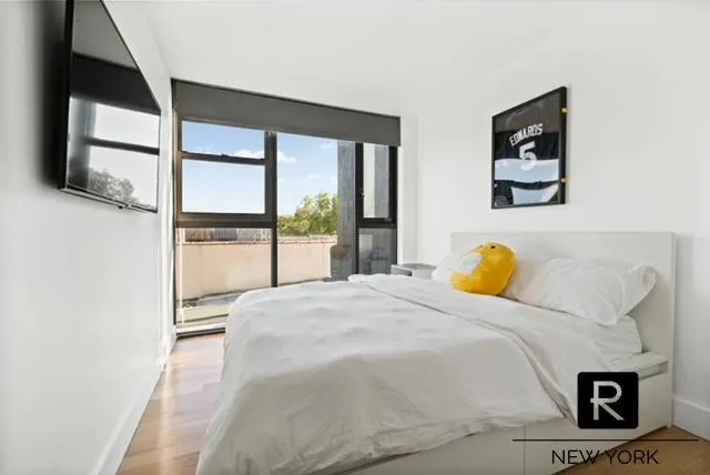 a bed sitting in a bedroom next to a window