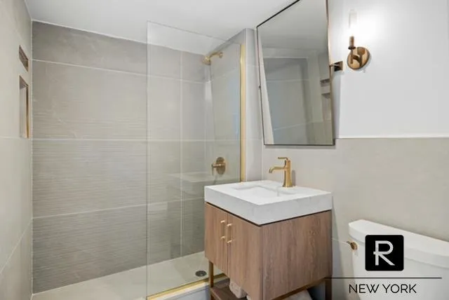 a bathroom with a sink a mirror and a shower