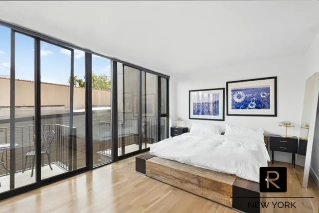 a bedroom with a large bed and a tv