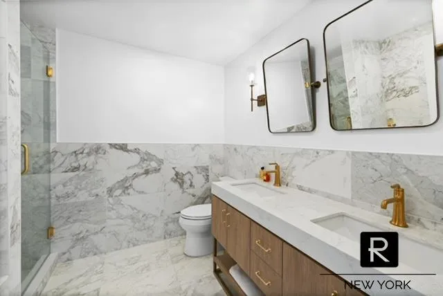 a bathroom with a toilet sink and mirror