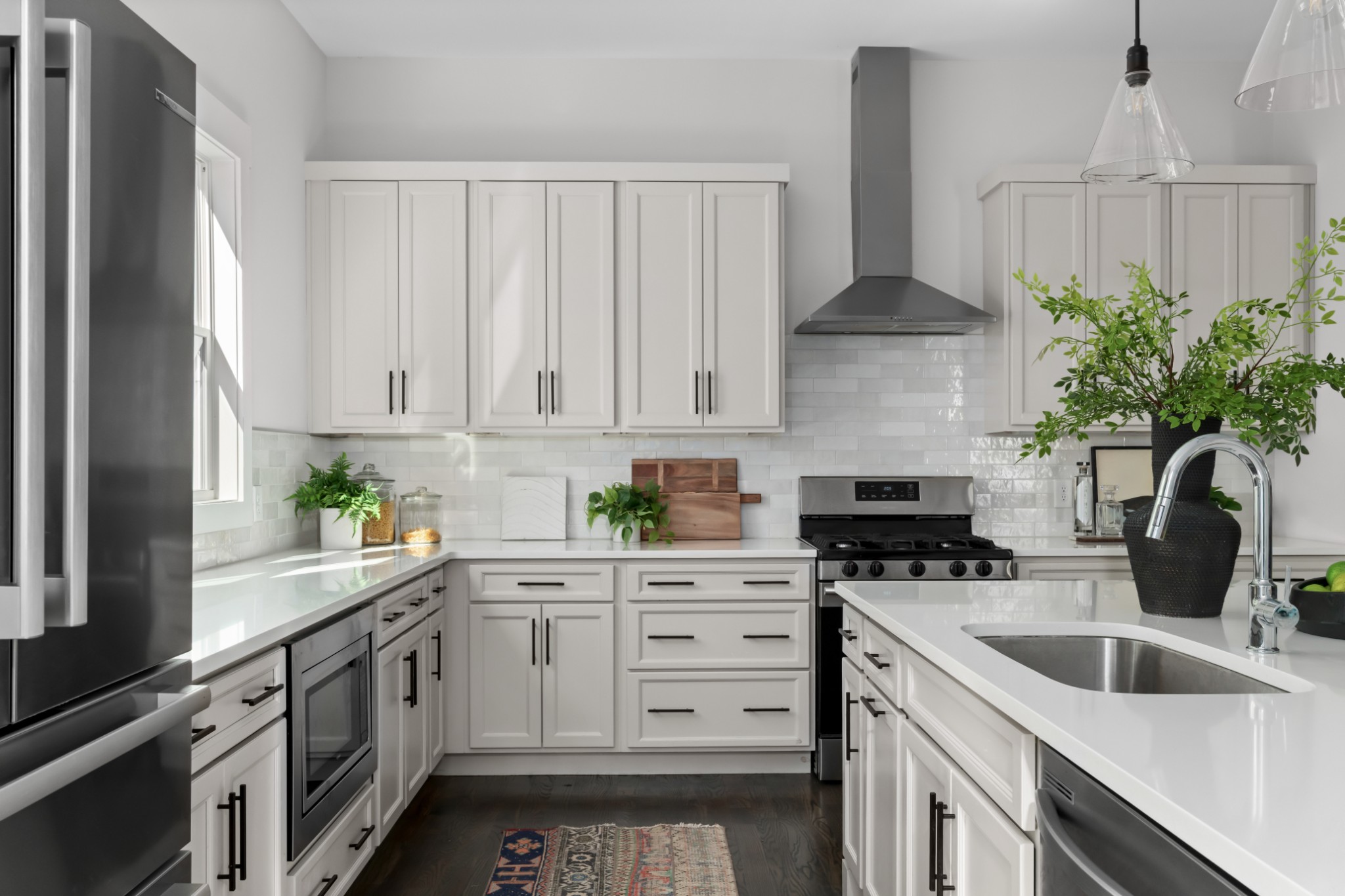 2 B Belle Forrest Avenue Nashville, TN 37206 - Photo 2 of 53 a kitchen with white cabinets a sink a stove a chimney and a refrigerator