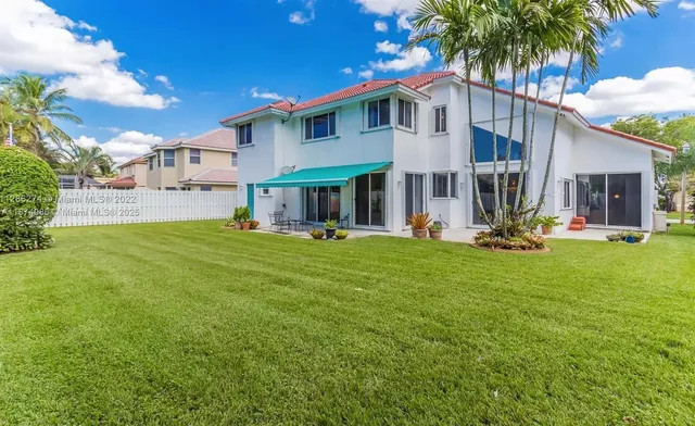 a front view of house with yard and outdoor seating
