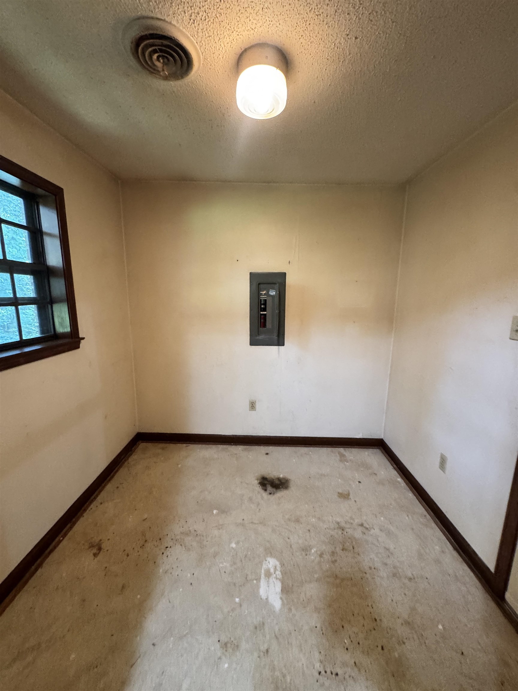 4334 Timber Rise Road Memphis, TN 38125 - Photo 9 of 18 Compact interior space featuring a window with dark trim, an electrical panel, and a ceiling-mounted light fixture